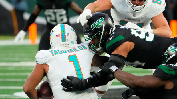 Nov 24, 2023; East Rutherford, New Jersey, USA; New York Jets defensive end Solomon Thomas (94) sacks Miami Dolphins quarterback Tua Tagovailoa (1) in then second quarter at MetLife Stadium. Mandatory Credit: Robert Deutsch-USA TODAY Sports